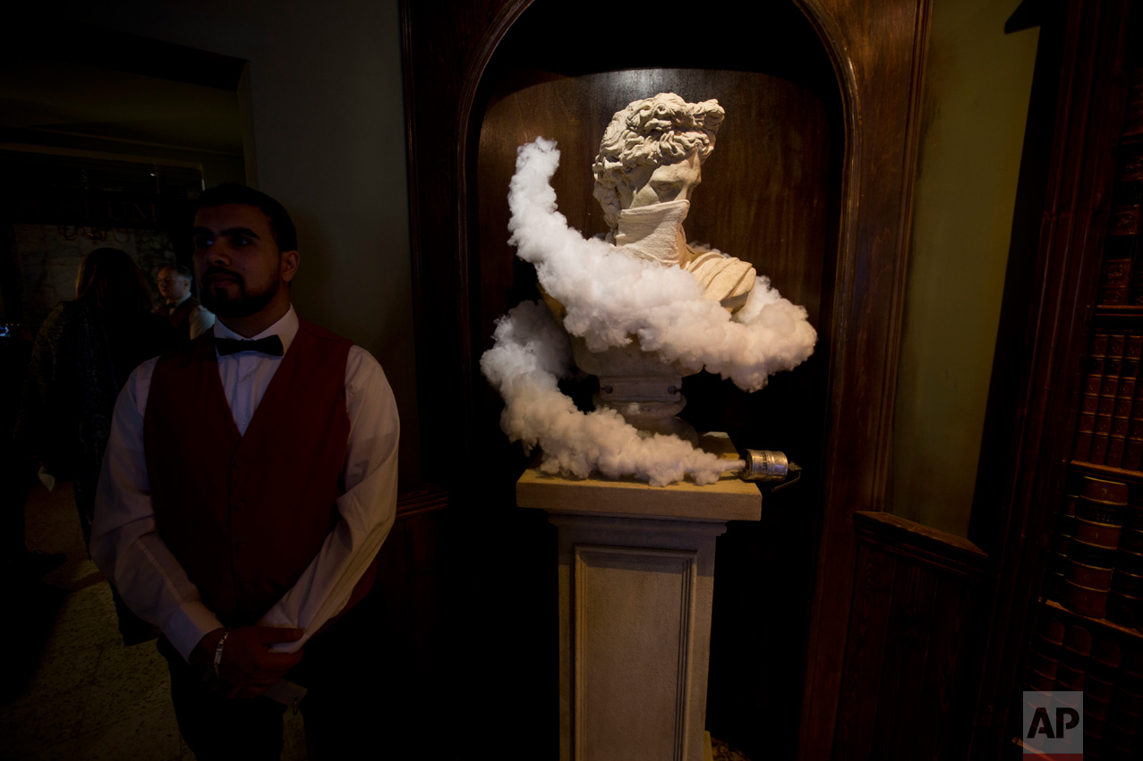  An employee stands in the restaurant area of the The Walled Off Hotel" in the West Bank city of Bethlehem, Friday, March 3, 2017. The owner of a guest house packed with the elusive artist Banksy's work has opened the doors of his West Bank establish