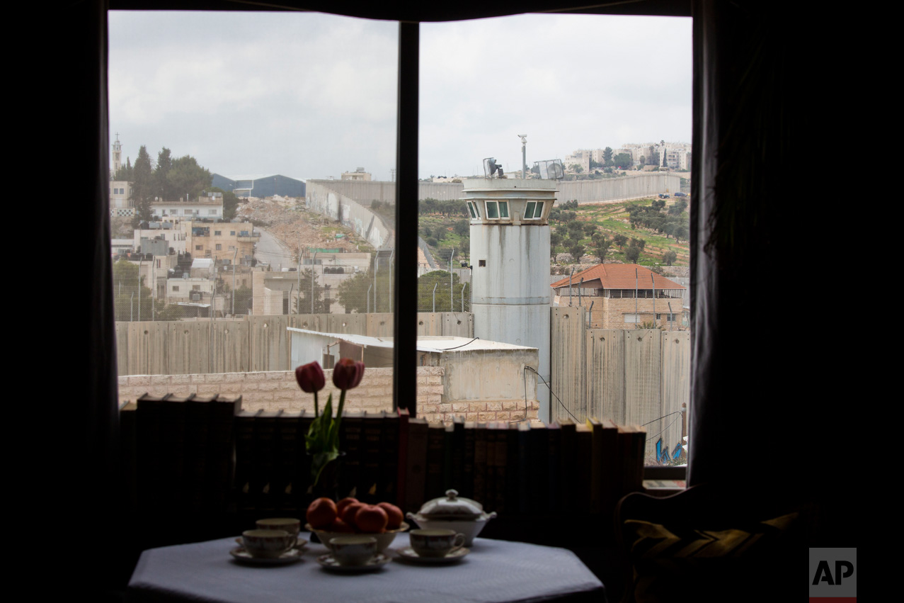  An Israeli security watch tower is seen from one of the rooms of the "The Walled Off Hotel" in the West Bank city of Bethlehem, Friday, March 3, 2017. The owner of a guest house packed with the elusive artist Banksy's work has opened the doors of hi