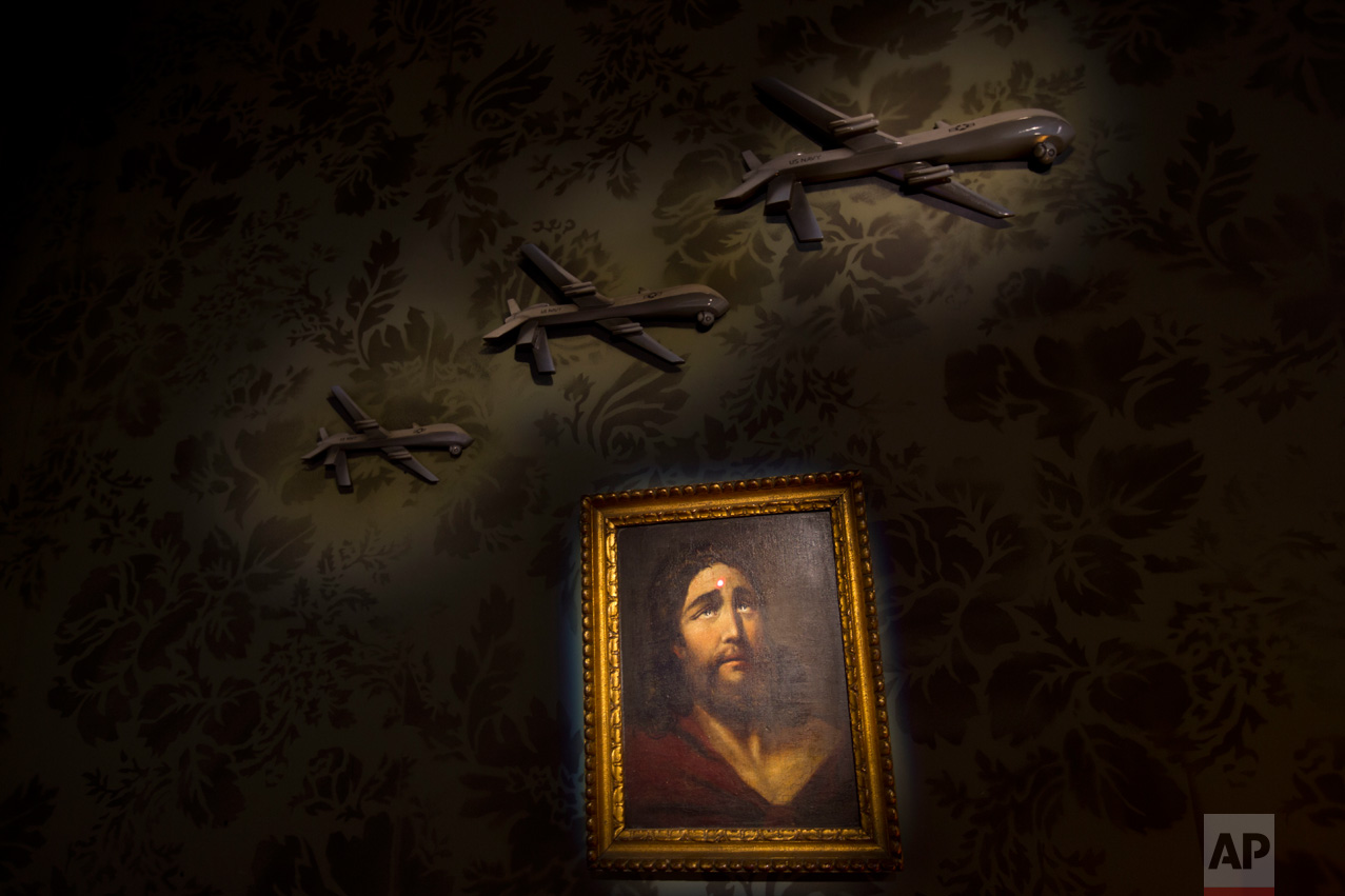  A wall decorated with models of drones and a painting of Jesus with a sniper's dot on his forehead is seen in the "The Walled Off Hotel" in the West Bank city of Bethlehem, Friday, March 3, 2017. The owner of a guest house packed with the elusive ar