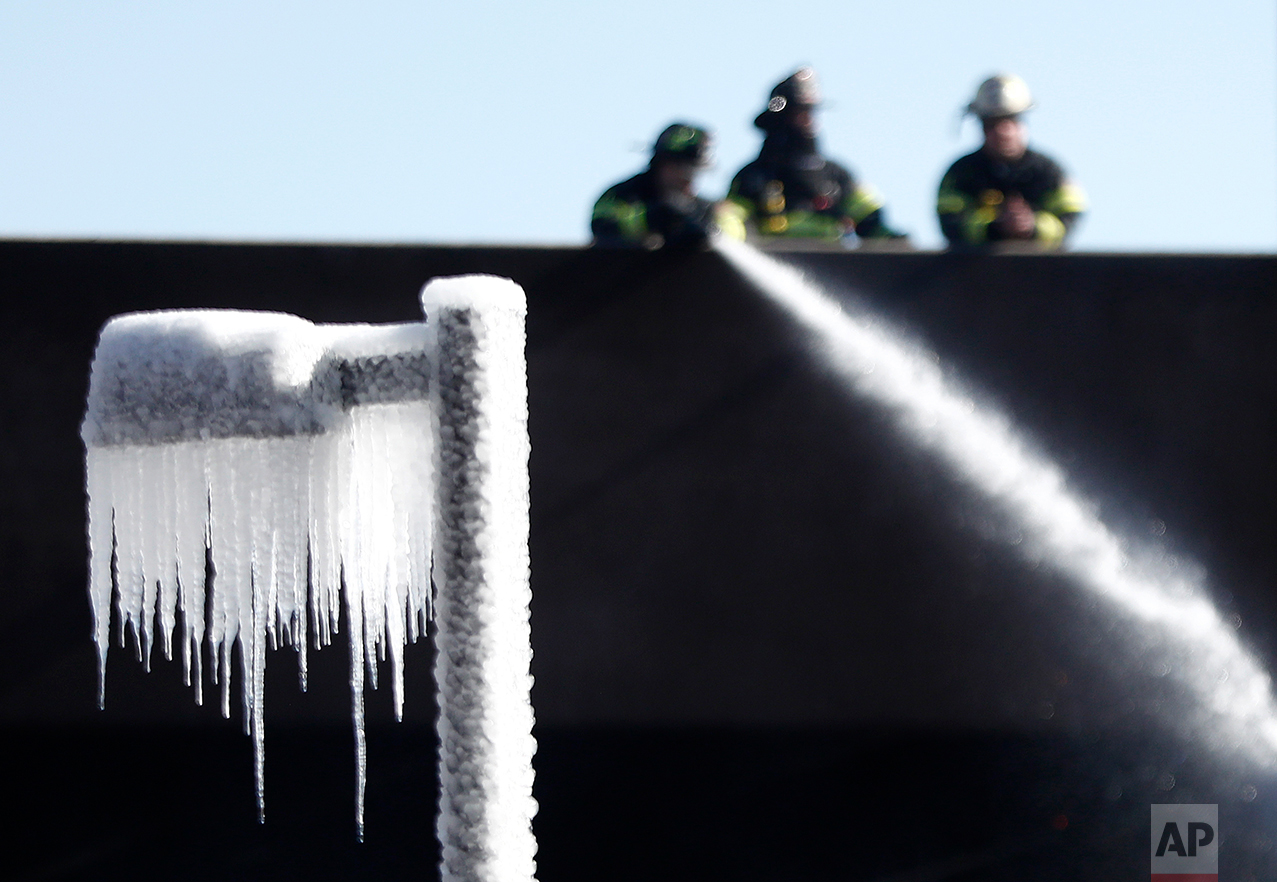  Icicles are formed on a street lamp as firefighters douse over an area at a large apartment complex, Saturday, Feb. 4, 2017, in Maplewood, N.J. Authorities said the fast-moving fire has destroyed most of the luxury apartment complex that was about t