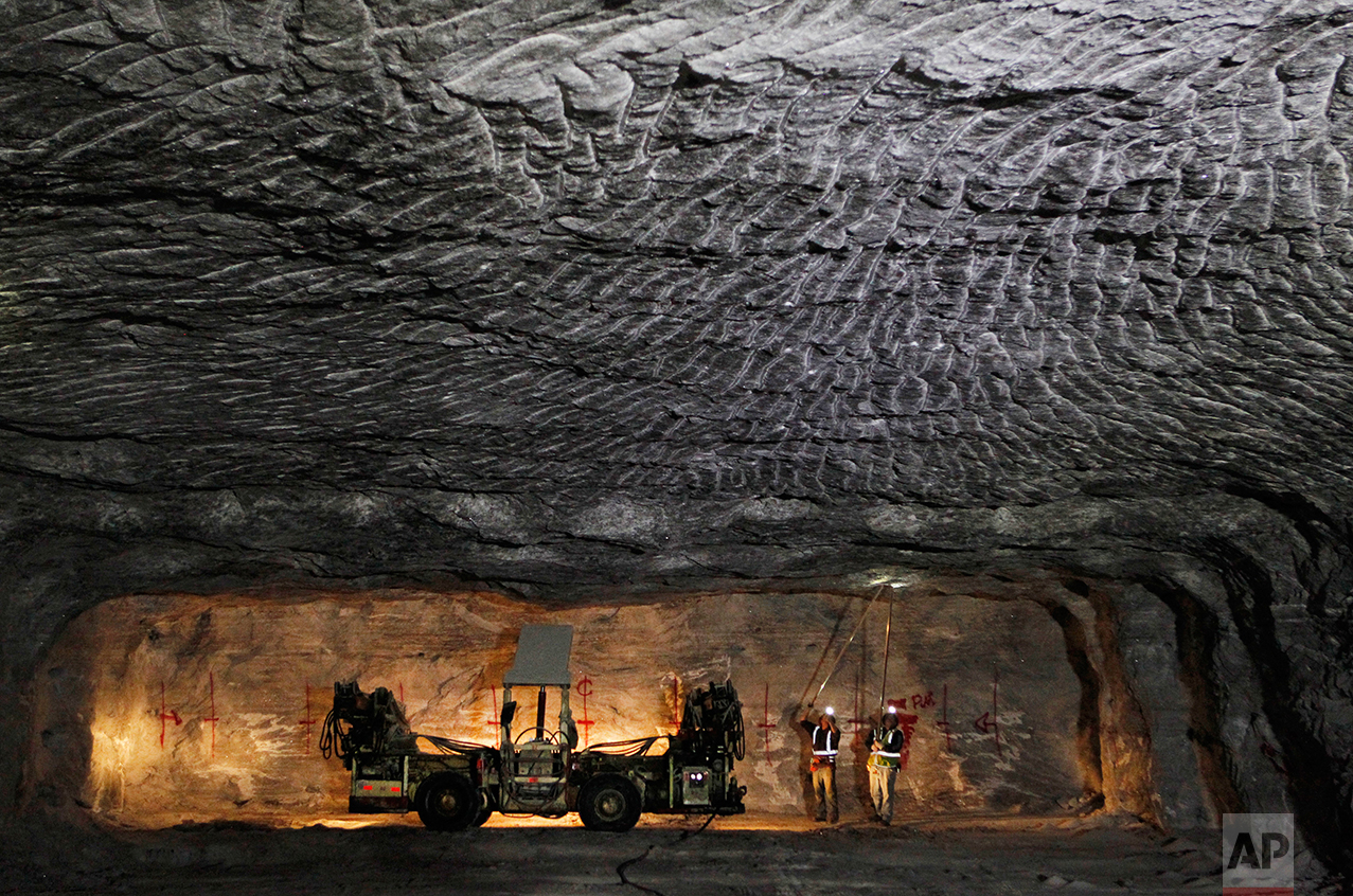  In this Jan. 27, 2017 photo, American Rock Salt Co. workers use hand scalers to remove loose roof material at the mine in Hampton Corners, N.Y. Deep below upstate New York’s farm country, workers in ghostly tunnels are praying for snow. Fiercer wint