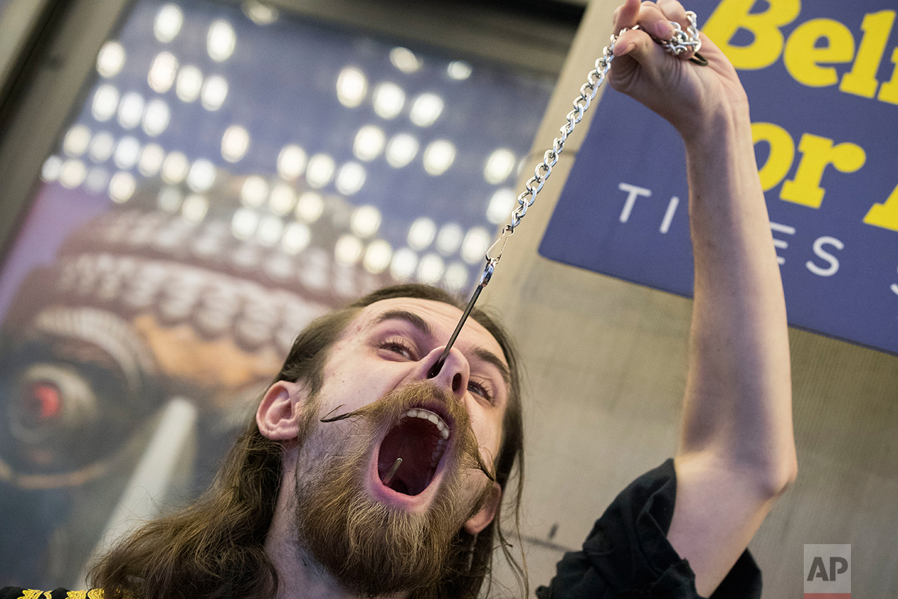  Kyle Mertz, of Emmaus, Pa., performs with a giant fishing hook during the 10th annual World Sword Swallower's Day at the Ripley's Believe it or Not!, Saturday, Feb. 25, 2017, in New York's Times Square. (AP Photo/Mary Altaffer) 