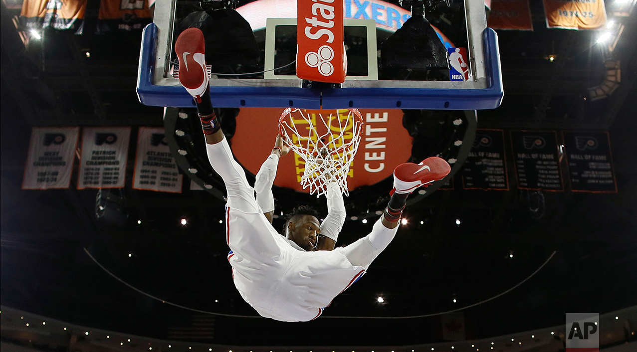  Philadelphia 76ers' Robert Covington hangs on the rim after a dunk during the second half of an NBA basketball game against the San Antonio Spurs, Wednesday, Feb. 8, 2017, in Philadelphia. San Antonio won 111-103. (AP Photo/Matt Slocum) 