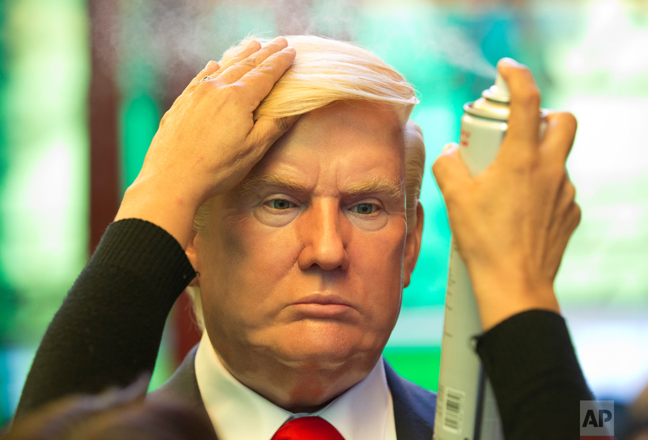  Museum worker Monica Alcantara adjusts the hair on a wax replica of U.S. President Donald Trump at the Wax Museum in Mexico City, Wednesday, Feb. 1, 2017. The wax figure of Trump went on display the day of his inauguration, Jan. 20, and currently st