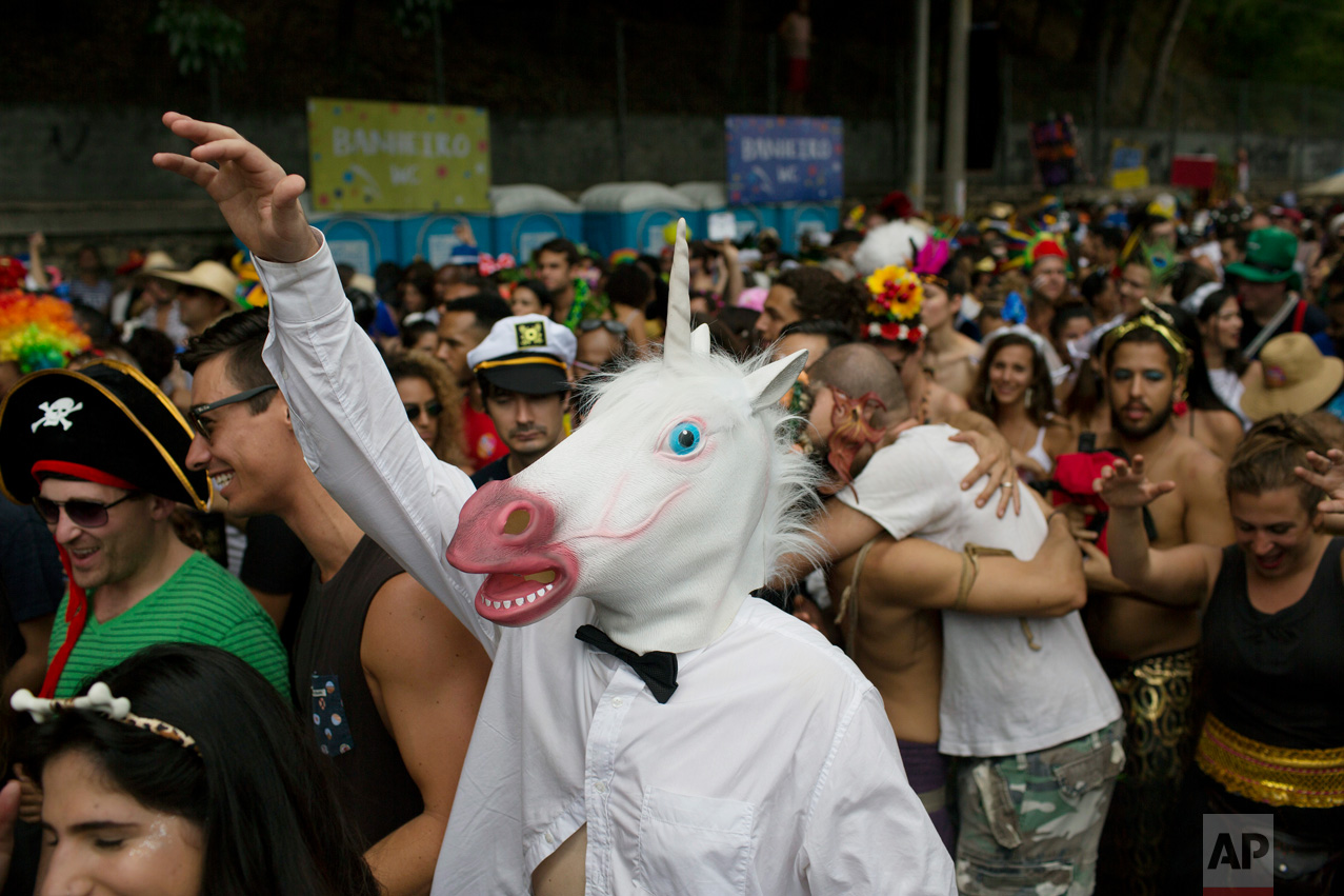 A reveler wearing a unicorn mask enjoys the "Ceu na Terra" or Heaven on Earth street party in Rio de Janeiro, Brazil, Saturday, Feb. 25, 2017. Merrymakers take to the streets in hundreds of open-air "bloco" parties during Rio's over-the-top Carnival, the highlight of the year for many. (AP Photo/Leo Correa)