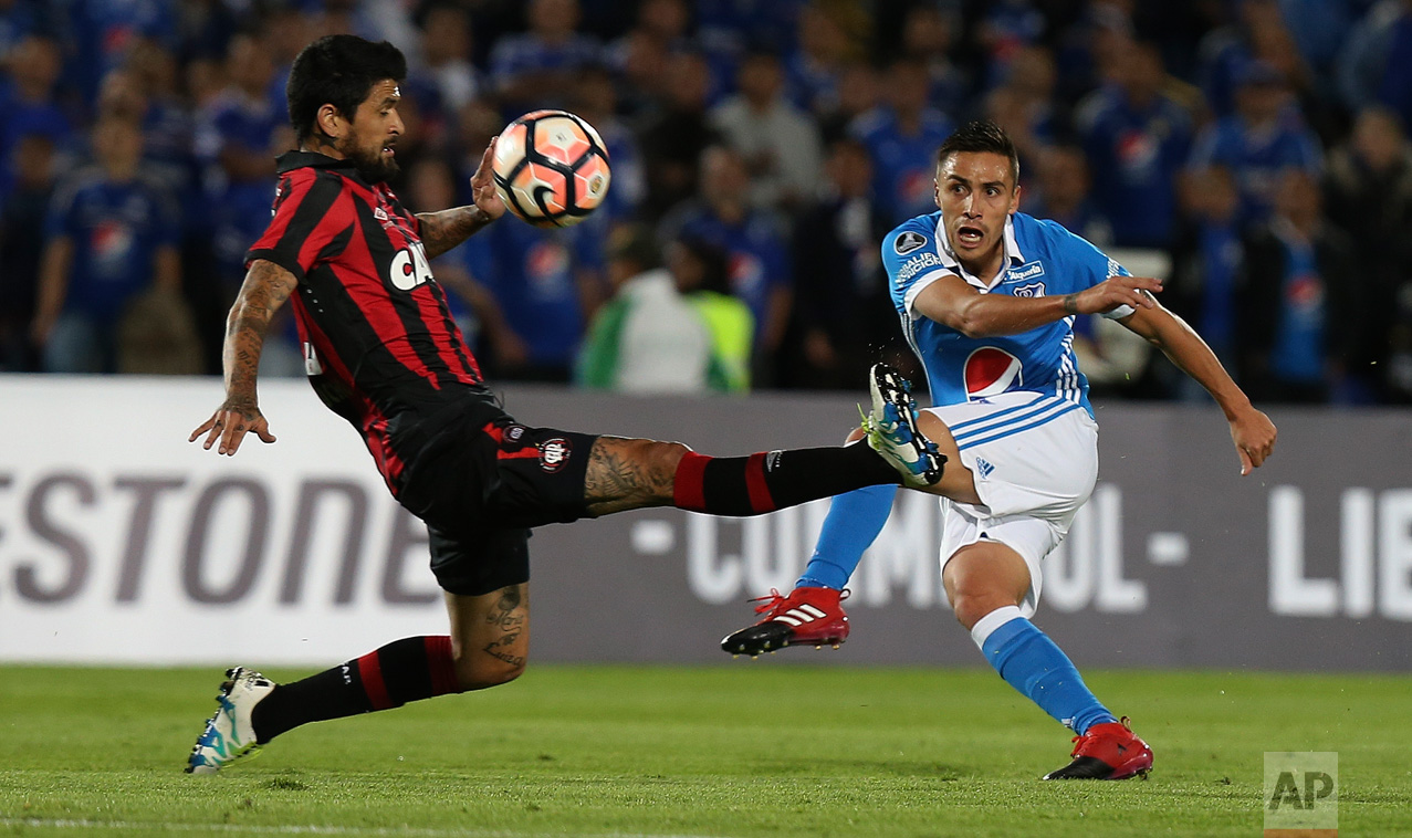  Lucho Gonzalez of Brazil's Atletico Paranaense, left, tries to block a kick by Henry Rojas of Colombia's Millonarios, during a Copa Libertadores soccer match in Bogota, Colombia, Wednesday, Feb. 8, 2017. (AP Photo/Fernando Vergara) 