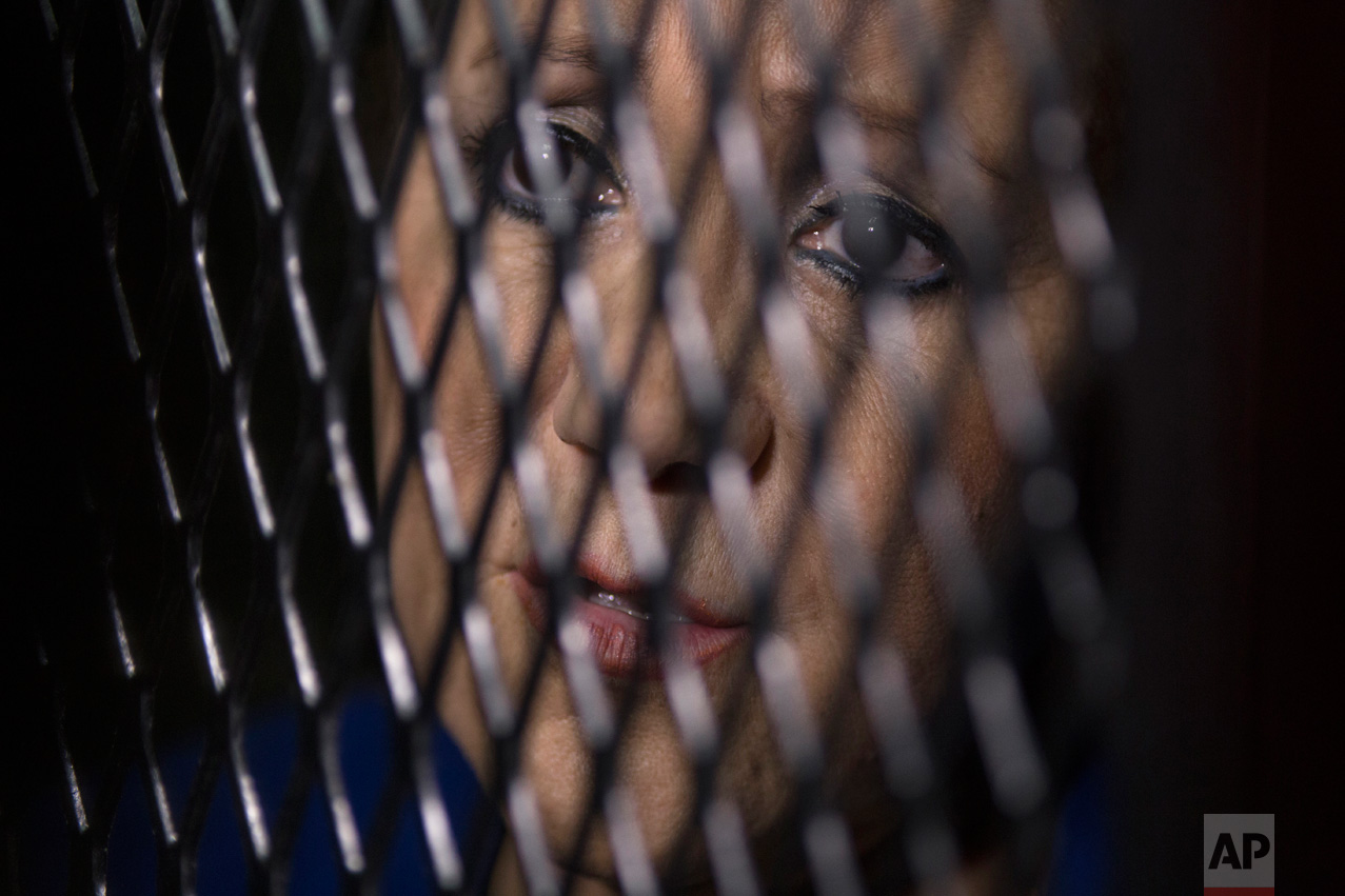  Supreme Court Justice Blanca Stalling looks out from a cell at a court in Guatemala City, Wednesday, Feb. 8, 2017. Prosecutors in Guatemala say Stalling has been arrested on a charge of influence peddling for trying to help her son in a corruption c