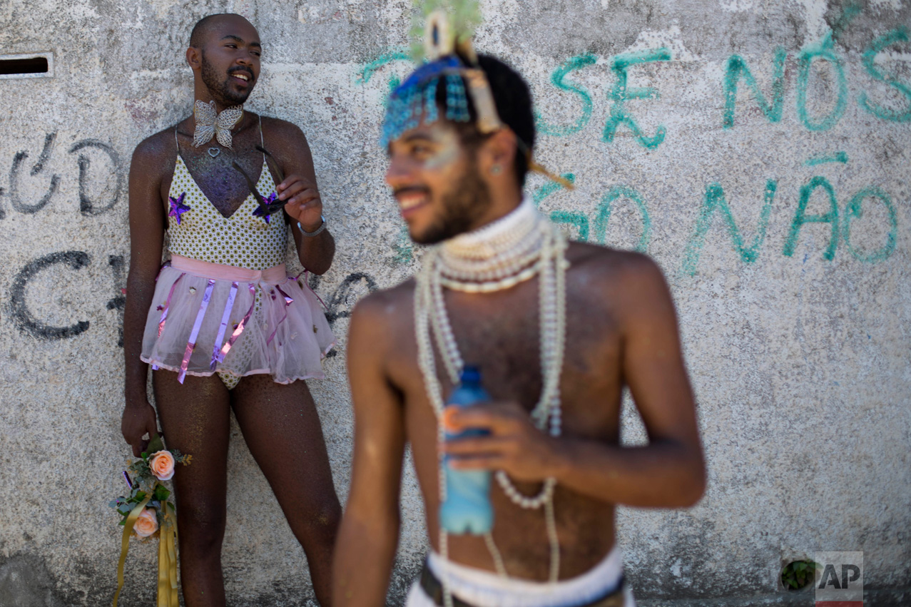 Revelers take part in the "Guanabara Pearl" carnival street party at Paqueta island, in Rio de Janeiro, Brazil, Saturday, Feb. 18, 2017. Merrymakers ferry cross Guanabara Bay to Paqueta island to participate in the "Guanabara Pearl" parade. (AP Photo/Mauro Pimentel)