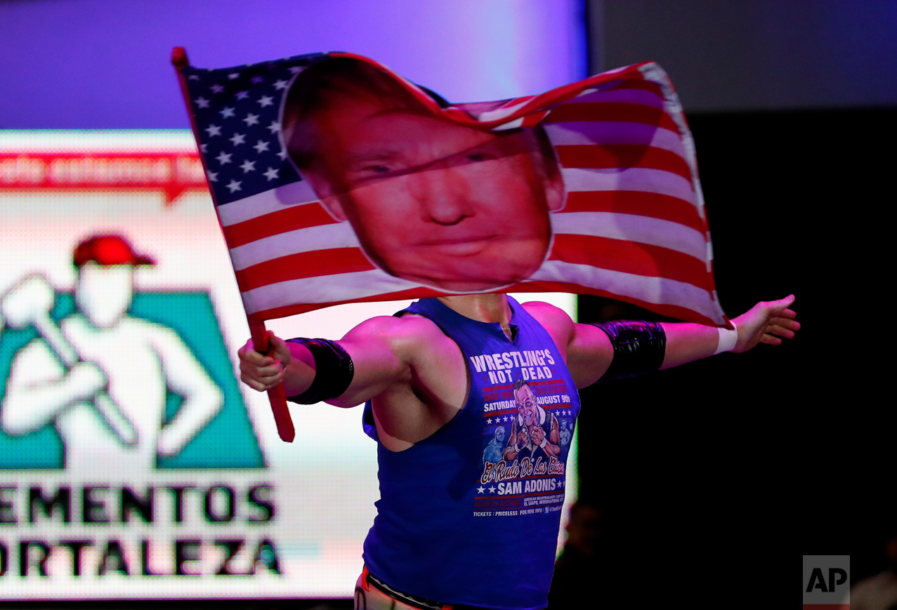  American pro wrestler Sam Polinsky aka Sam Adonis takes the ring at Arena Mexico waving an American flag emblazoned with a photo of U.S. President Donald Trump, in Mexico City, Sunday, Feb. 12, 2017. He's the guy Mexicans love to hate: The wrestler 