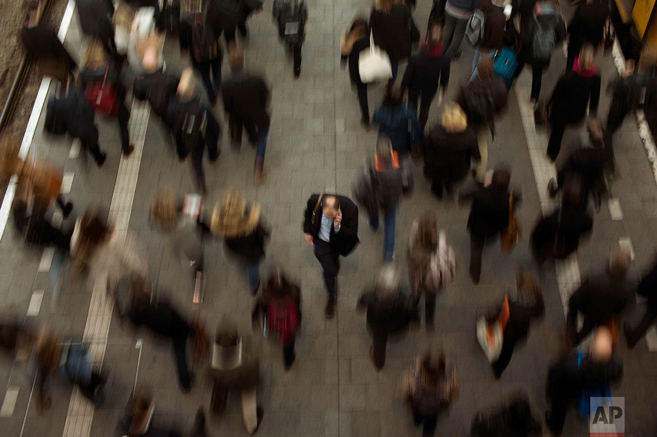 In this Monday, March 6, 2017 photo, pedestrians walk along a platform at the central station in The Hague, The Netherlands. Of The Netherlands' 17 million people, just over one in five now have a migrant background _ rising to roughly half-and-half in the Netherlands' four largest melting-pot cities: Amsterdam, Rotterdam, Utrecht and The Hague. (AP Photo/Emilio Morenatti)