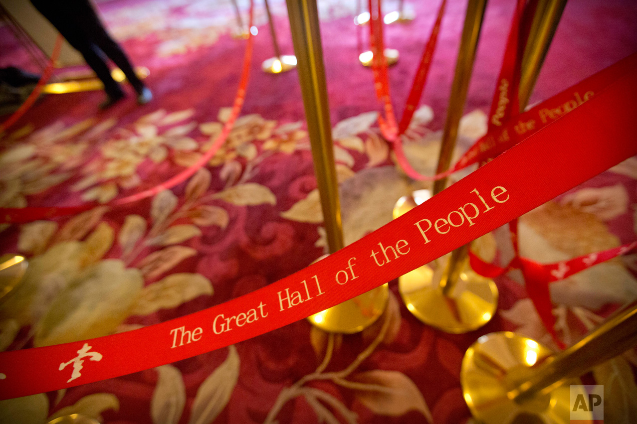 In this Wednesday, March 8, 2017 photo, a man stands near rope lines used to line up journalists during a plenary session of China's National People's Congress (NPC) at the Great Hall of the People in Beijing. (AP Photo/Mark Schiefelbein)
