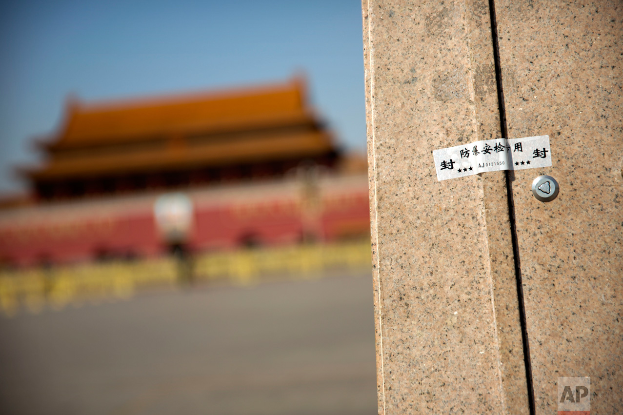 In this Friday, March 10, 2017 photo, an anti-tampering security sticker seals a panel at the base of a light pole on Tiananmen Square near the Great Hall of the People before a plenary session of the Chinese People's Political Consultative Congress (CPPCC) in Beijing. (AP Photo/Mark Schiefelbein)