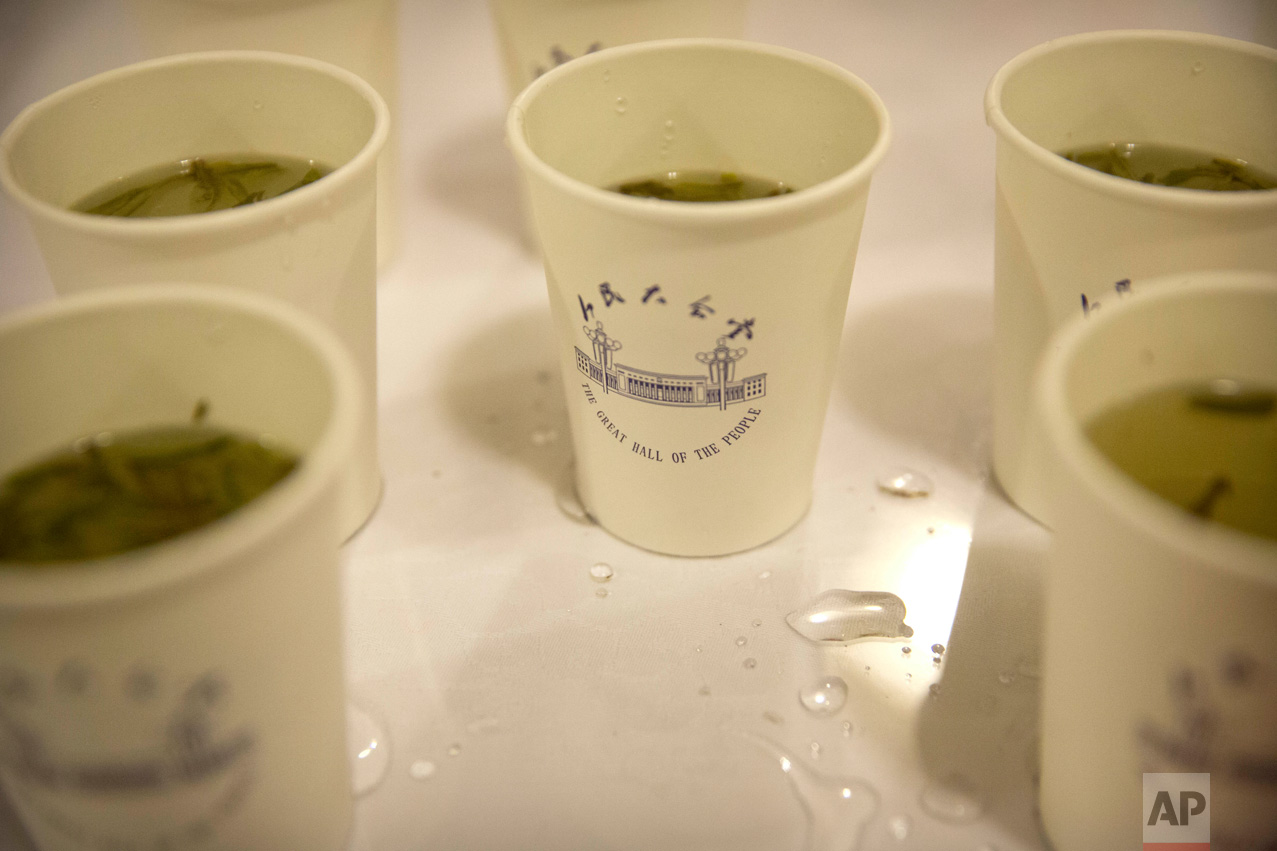 In this Friday, March 10, 2017 photo, cups of green tea bearing an image of the Great Hall of the People are available for delegates and visitors during a plenary session of the Chinese People's Political Consultative Congress (CPPCC) in Beijing. (AP Photo/Mark Schiefelbein)