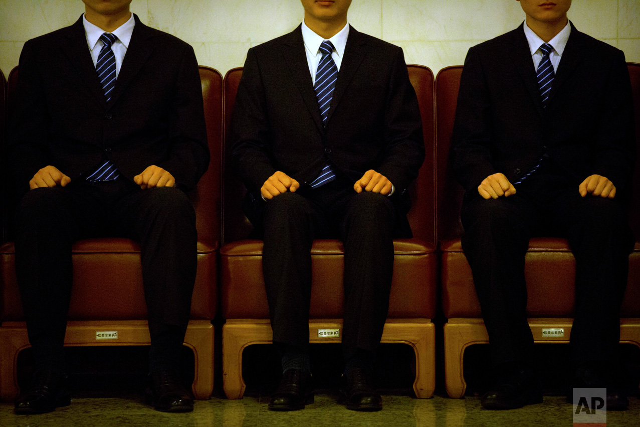 In this Wednesday, March 8, 2017 photo, security personnel sit in chairs while on guard duty during a plenary session of China's National People's Congress (NPC) at the Great Hall of the People in Beijing. (AP Photo/Mark Schiefelbein)