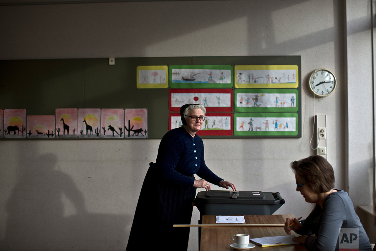  A woman casts her ballot for Dutch general elections at a polling station set up in a school in Staphorst, Netherlands, Wednesday, March 15, 2017. (AP Photo/Muhammed Muheisen) 
