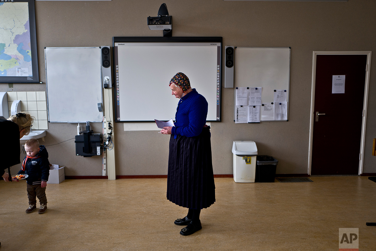  An elderly woman waits her turn to receive her ballot prior to casting her vote for Dutch general elections at a polling station set up in a school in Staphorst, Netherlands, Wednesday, March 15, 2017. &nbsp;(AP Photo/Muhammed Muheisen) 