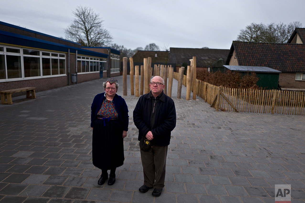  Klaas Dozeman, 65, right, and his wife Jantje, 58, of Netherlands, pose for a photo after casting their ballots for the Dutch general elections outside a polling station set up in a school in Staphorst, Netherlands, Wednesday, March 15, 2017. (AP Ph