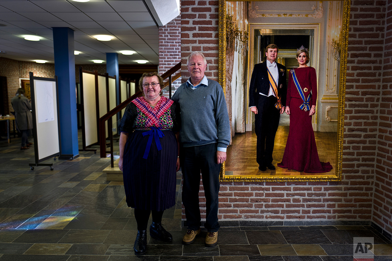  Klaas de Haan, 69, right and his wife Aaltje, 67, left, of Netherlands pose for a picture after casting their ballots for the Dutch general elections inside a polling station set up in the city hall in Staphorst, Netherlands, Wednesday, March 15, 20