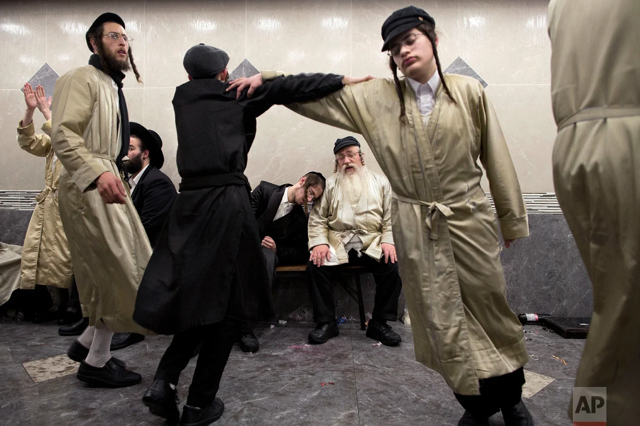 Intoxicated ultra-Orthodox Jewish men celebrate the holiday of Purim in the Mea Shearim neighborhood of Jerusalem, Monday, March 13, 2017. Purim celebrates the Jews' salvation from genocide in ancient Persia, as recounted in the Scroll of Esther. (AP Photo/Oded Balilty)