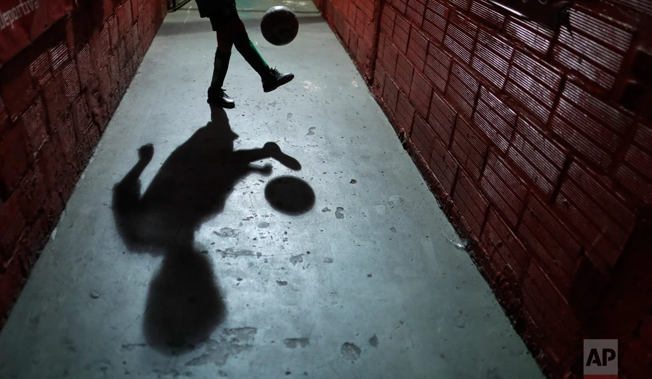 In this Nov. 11, 2016 photo, a child plays with a ball at the youth soccer academy, Club Social Parque, in a working class neighborhood of Buenos Aires, Argentina. Club Social Parque is the same soccer talent factory where international stars like Diego Maradona, Carlos Tevez and Juan Roman Riquelme polished their skills as children. (AP Photo/Natacha Pisarenko)
