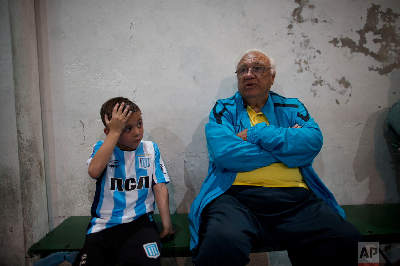 In this Nov. 11, 2016 photo, head soccer talent scout Ramon Maddoni, of Club Social Parque and Boca Juniors children's division, sits on the bench with young player Benjamin Palandella at the youth soccer academy Club Social Parque in a working class neighborhood of Buenos Aires, Argentina. "At Club Parque, we work a lot on the fundamentals, the technique. We recognize talent from a young age and our eye has been sharpening with time," said Maddoni. (AP Photo/Natacha Pisarenko)