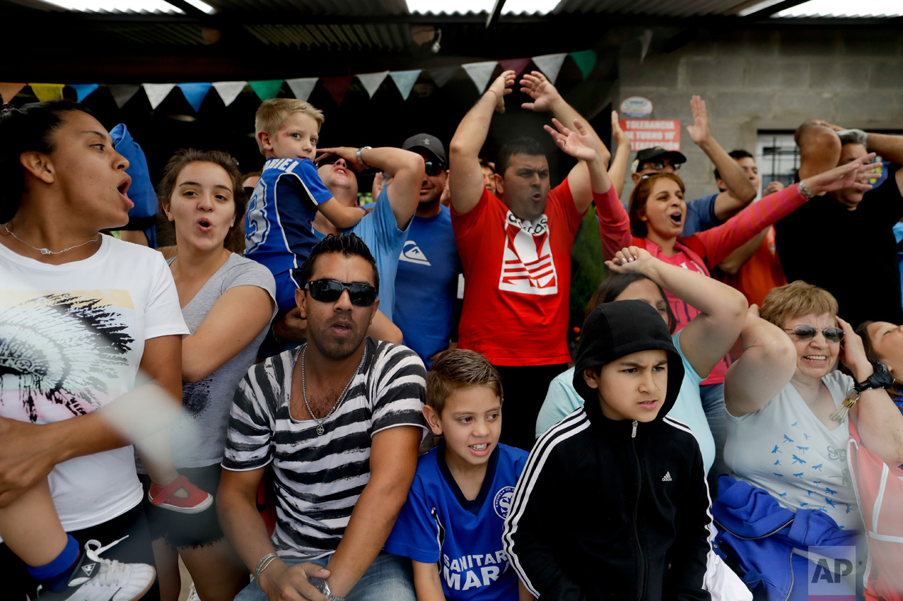 In this Nov. 19, 2016 photo, parents scream as their children play a league soccer game on the outskirts of in Buenos Aires, Argentina. For the thousands of talented youngsters, only a small percentage will become elite players. Some will struggle along the way to overcome injuries. Others will fall to the psychological pressure at home or on the field. (AP Photo/Natacha Pisarenko)