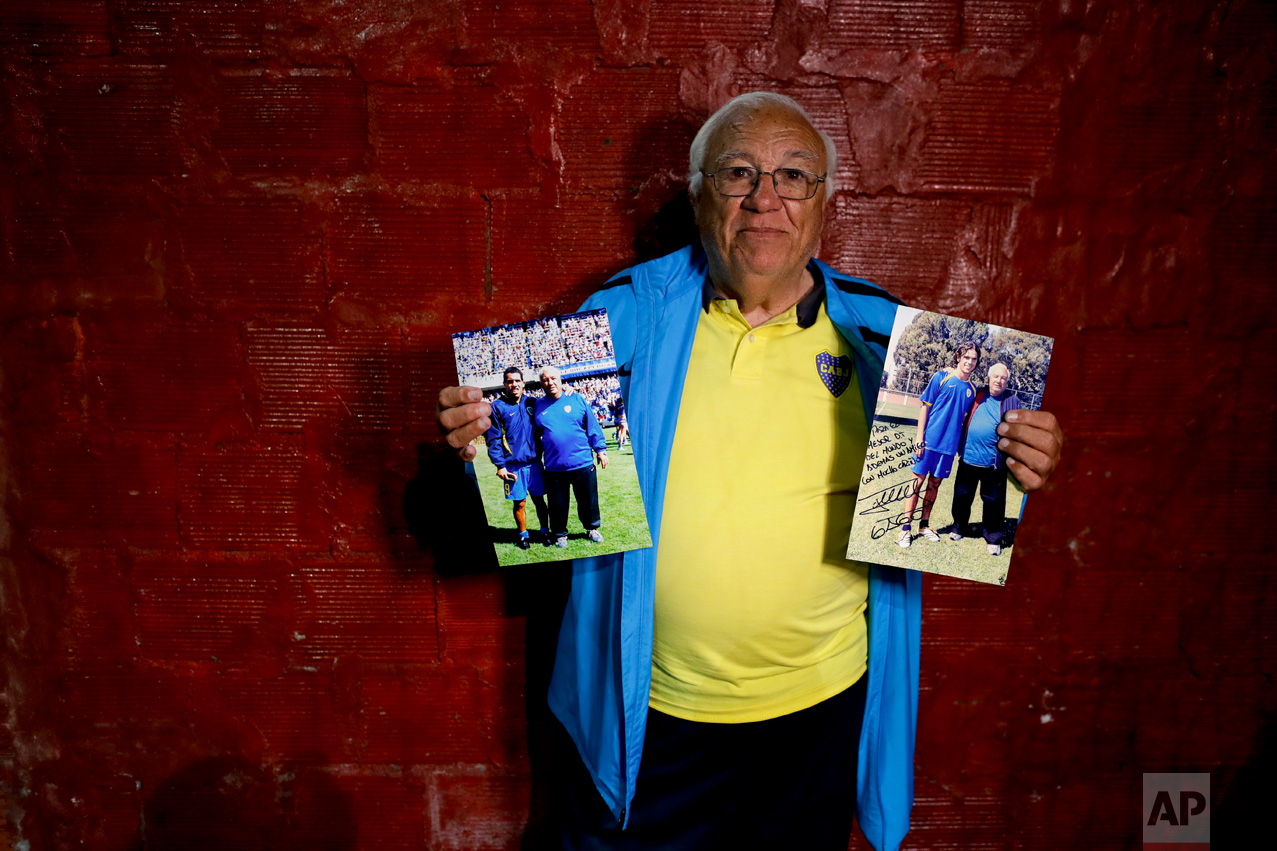 In this Nov. 11, 2016 photo, Ramon Maddoni, head scout at youth soccer academy Club Social Parque and at the Boca Juniors club children's division, poses with photos of himself with professional players Carlos Tevez and Fernando Gago in Buenos Aires, Argentina. Maddoni recalls how he promised Tevez that he'd be a world-class striker long before he became a top goal scorer for clubs in England and Italy. (AP Photo/Natacha Pisarenko)