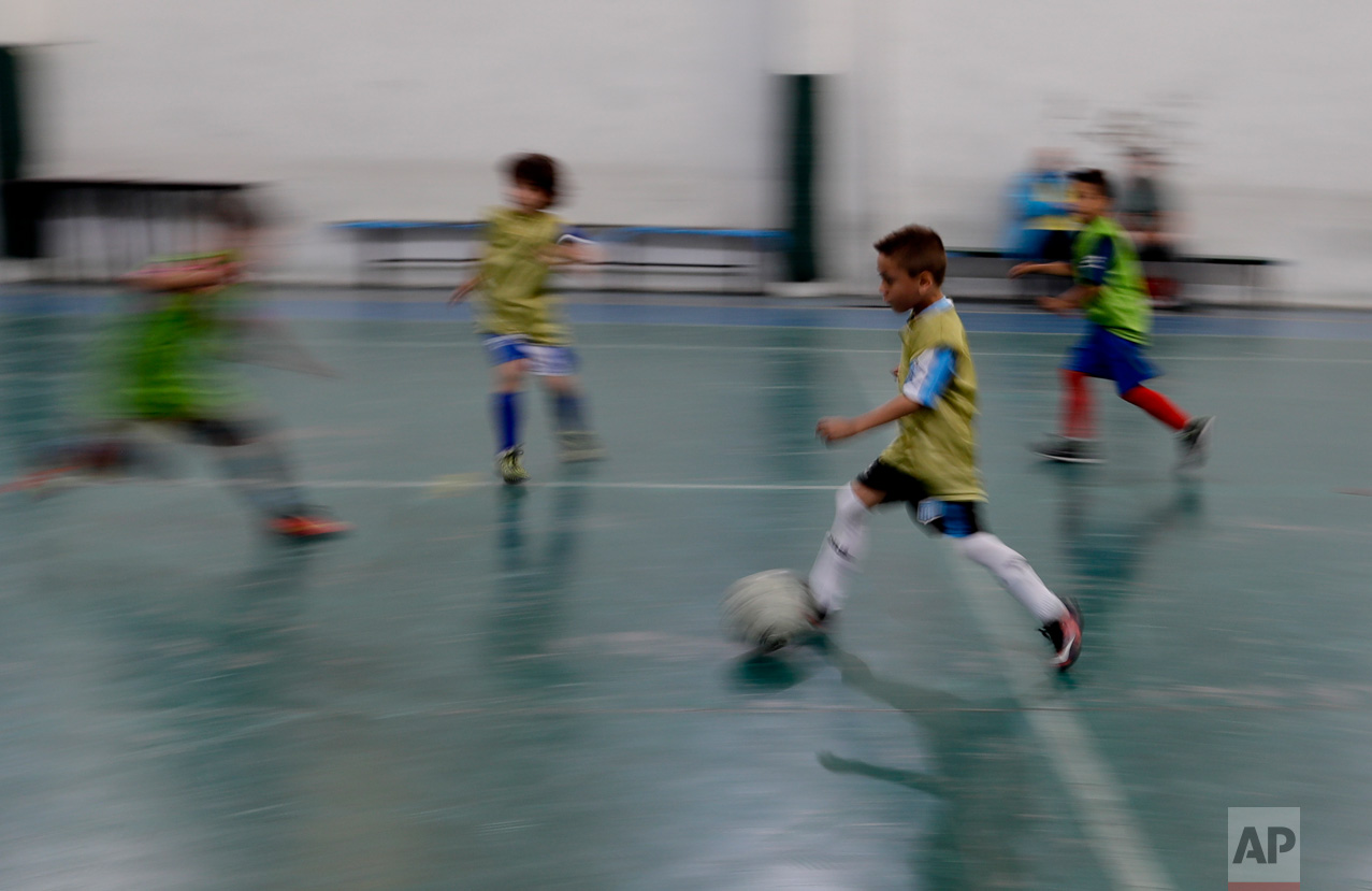 In this Nov. 11, 2016 photo, Benjamin Palandella controls the ball during a training session in Buenos Aires, Argentina. The 75-year-old coach of the youth soccer academy Club Social Parque likes to recite the names of the dozens of kids - more than 200 by his count - that he has coached and who went on to play with Argentina's national team and Europe's top clubs. (AP Photo/Natacha Pisarenko)