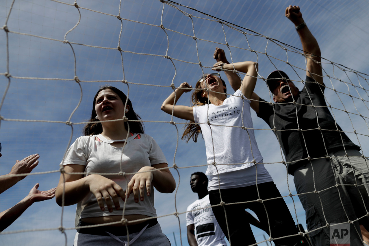In this Nov. 19, 2016 photo, parents scream as children play soccer at a youth league game on the outskirts of in Buenos Aires, Argentina. Some parents cheered as if they were witnessing the World Cup final as a coach barked orders at their kids on the sideline. (AP Photo/Natacha Pisarenko)