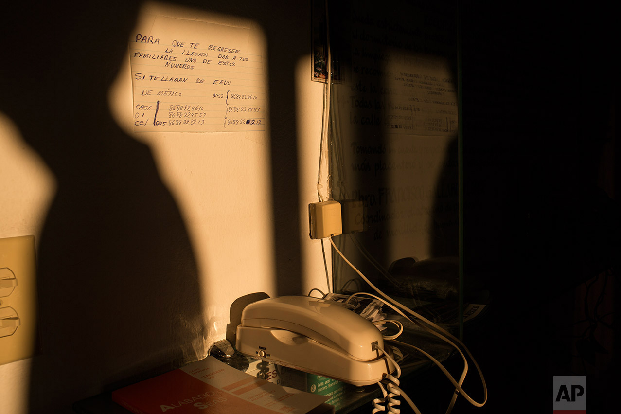 A phone used by migrants to call their families sits in the "Casa del Migrante" migrant shelter in Matamoros, Tamaulipas, Mexico, Wednesday, March 22, 2017. (AP Photo/Rodrigo Abd)