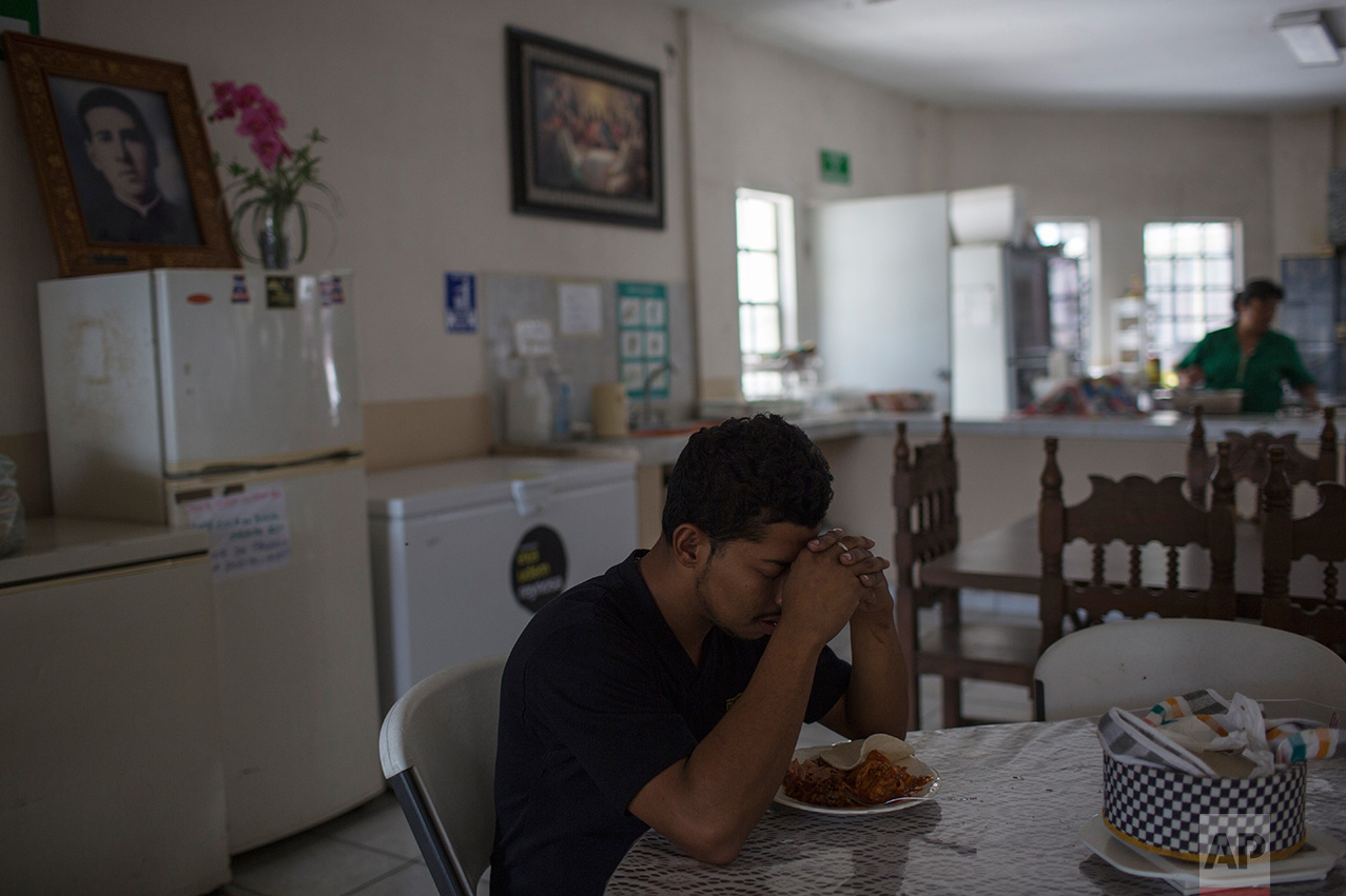 A deported migrant prays before eating lunch in "La Casa del Migrante" migrant shelter in Reynosa, Mexico, Wednesday, March 22, 2017. (AP Photo/Rodrigo Abd)