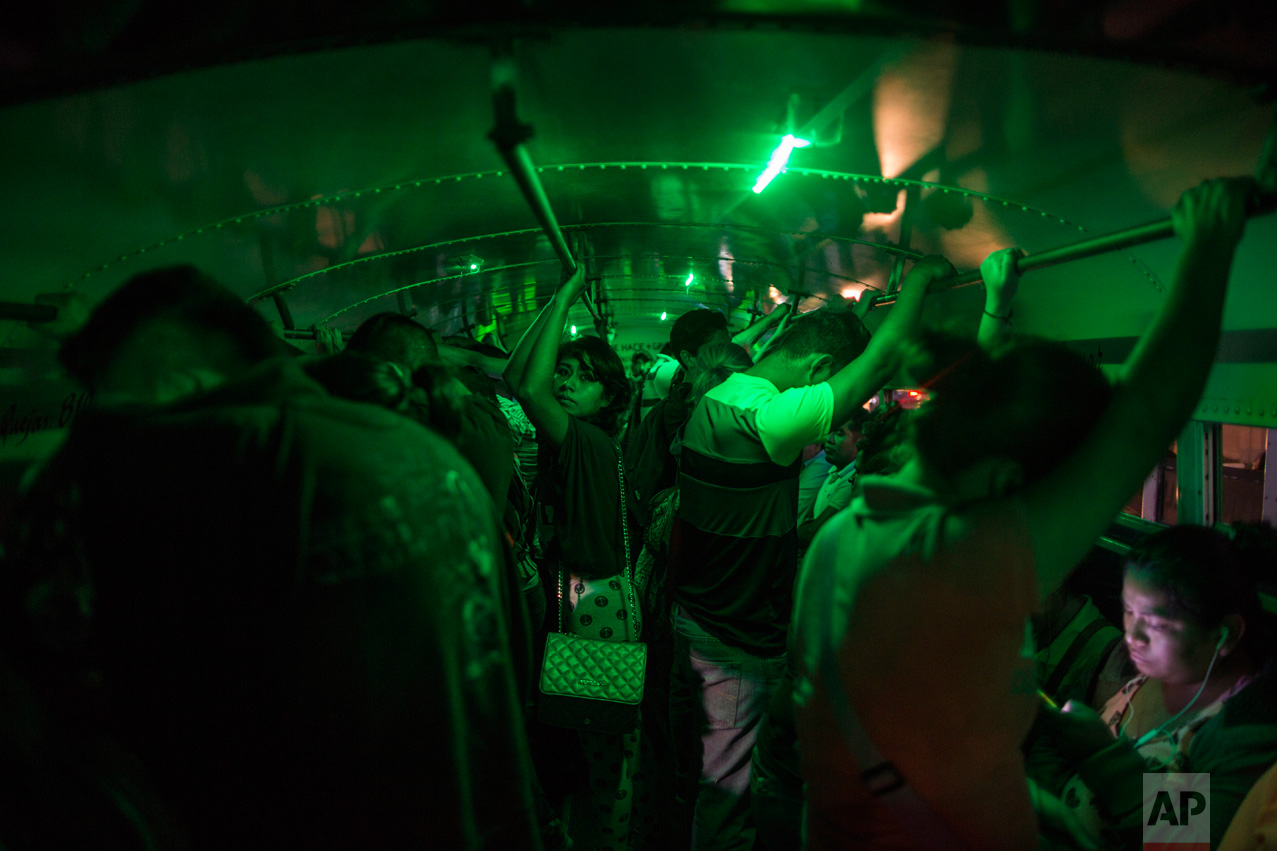 People stand in a bus waiting to go home after their work day at a "maquiladora" for car accessories in Matamoros, Tamaulipas state, Mexico, Tuesday, March 21, 2017, across the border from Brownsville, Texas. (AP Photo/Rodrigo Abd)