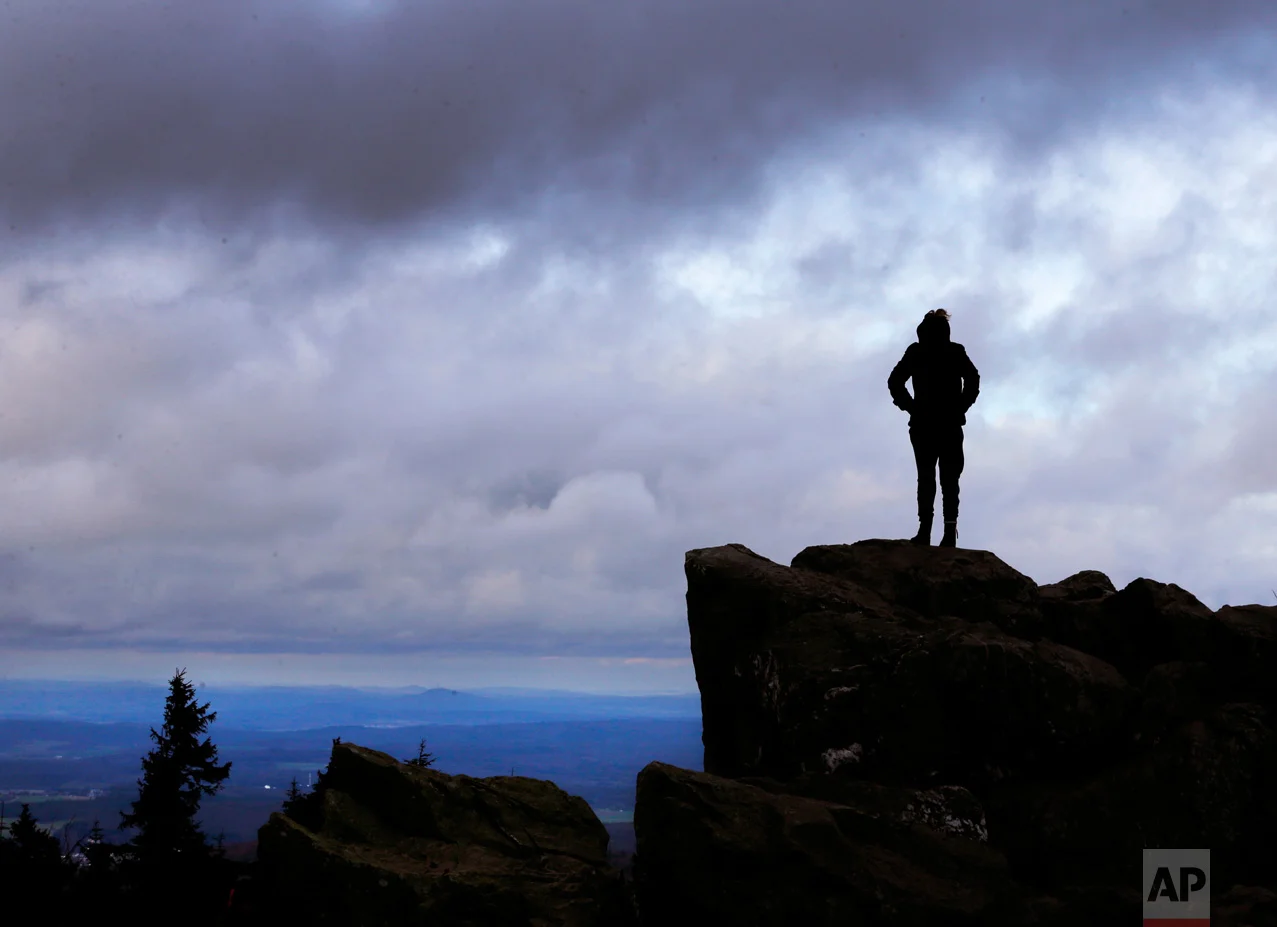 A woman stands on the top of Feldberg mountain near Frankfurt, Germany, on Sunday, March 19, 2017. (AP Photo/Michael Probst)