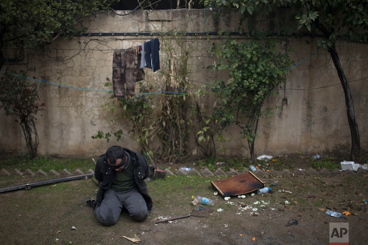 An alleged Islamic State fighter is detained by Iraqi security forces on the western side of Mosul, Iraq, on Thursday, March 23, 2017. The United Nations reported on Thursday that more than 1,000 people have been treated for conflict-related trauma near front lines since the fight for western Mosul began on Feb. 19. (AP Photo/Felipe Dana)