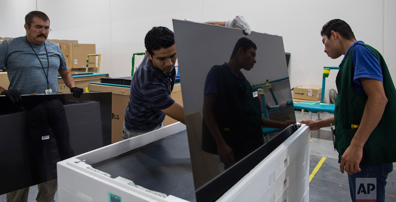 Workers checks tv screens for faults in Pantos logistics, a maquila that supports an LG flat screen television assembly plant, Reynosa, Tamaulipas, Mexico, Thursday, 23, 2017. (AP Photo/Rodrigo Abd)