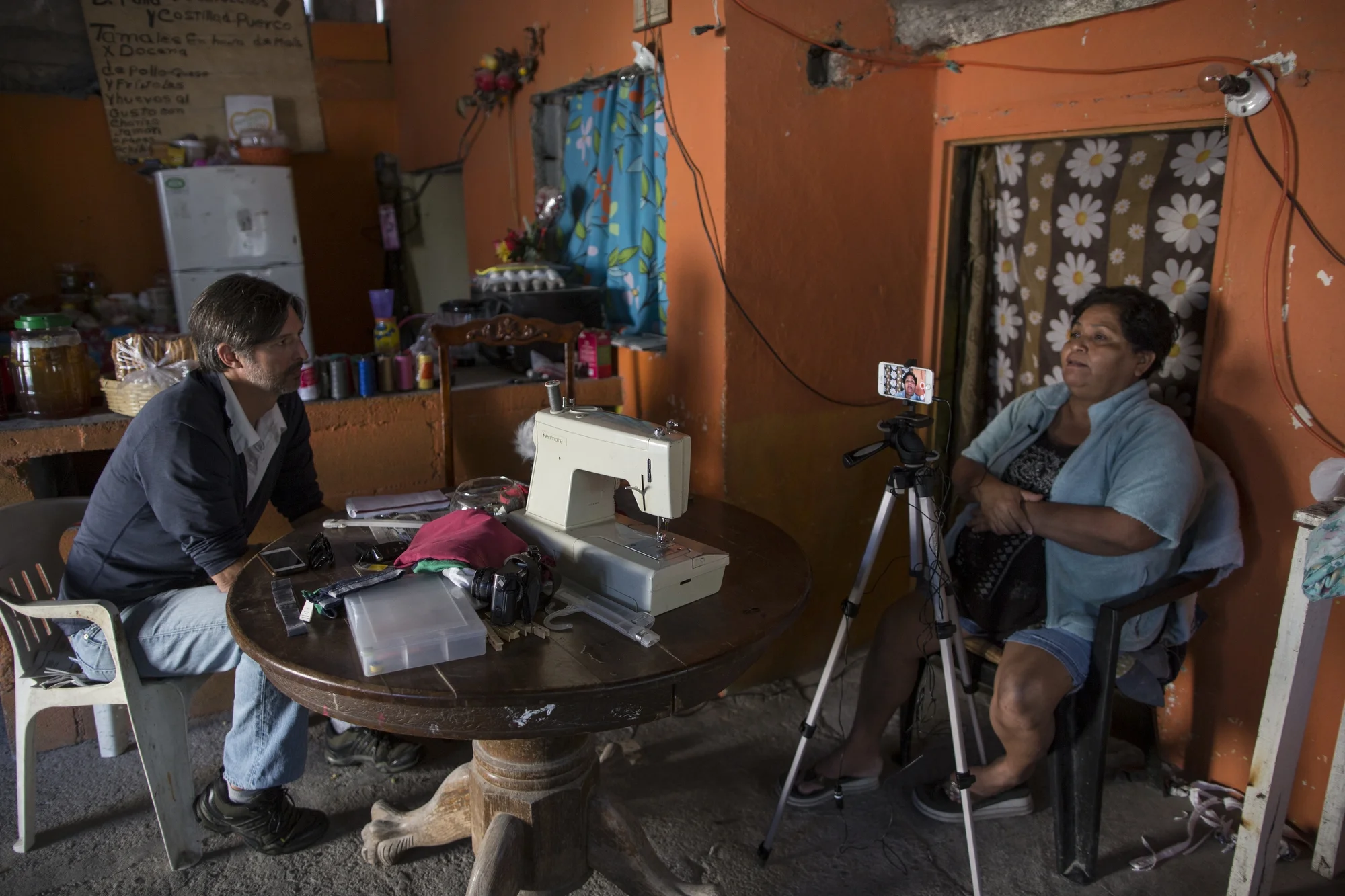 AP journalist Christopher Sherman interviews Jesus Esteban Cruz inside her home in Reynosa, Mexico, Wednesday, March 22, 2017, across the border from McAllen, Texas. (AP Photo/Rodrigo Abd)