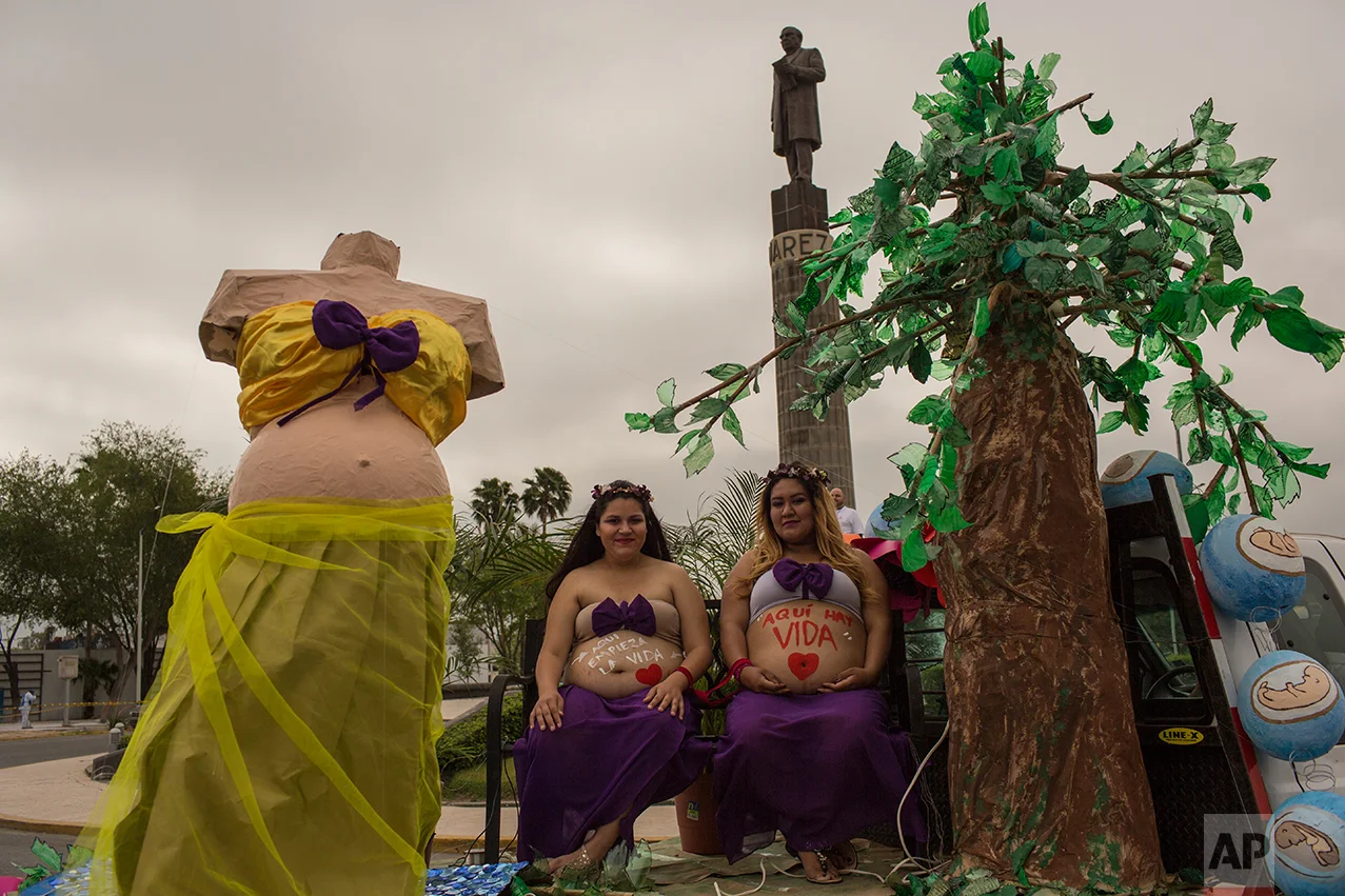 Pregnant women ride on a float during a march against violence organized by local churches in Nuevo Laredo, Tamaulipas state Mexico, Saturday March, 25, 2017. (AP Photo/Rodrigo Abd)