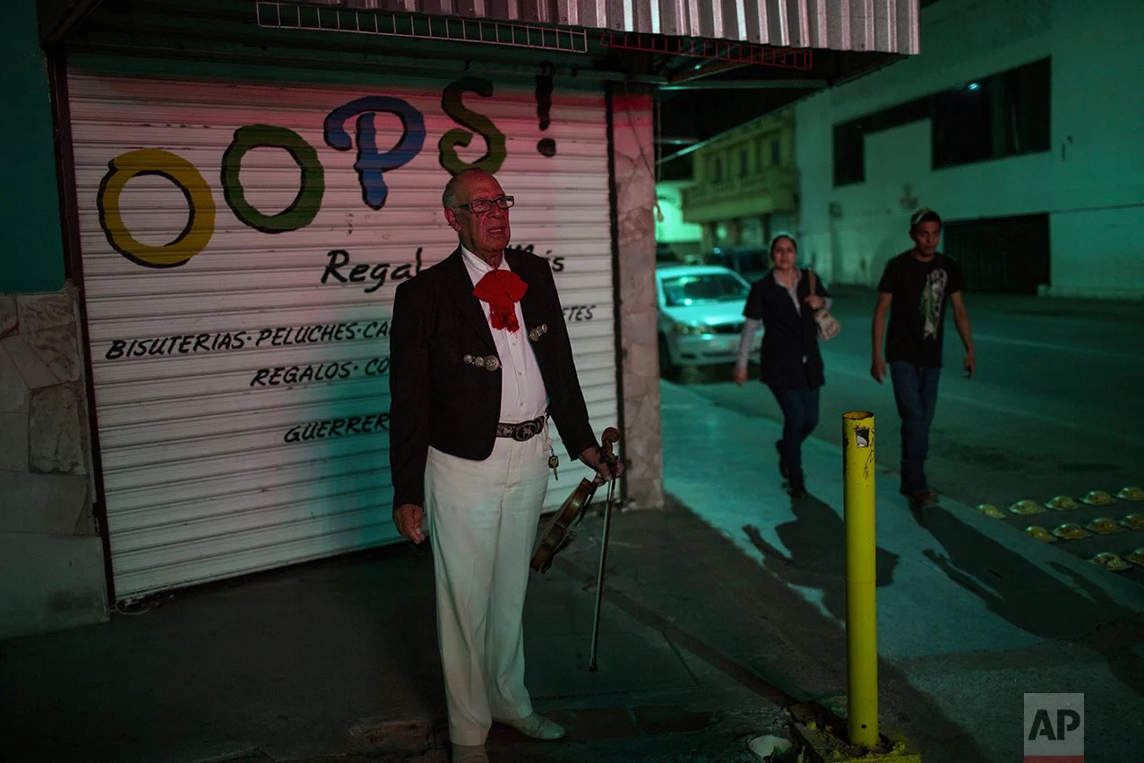 A mariachi waits for clients in downtown Nuevo Laredo, Tamaulipas state, Mexico, across the border from Laredo in the U.S, Friday March 24, 2017.(AP Photo/Rodrigo Abd)