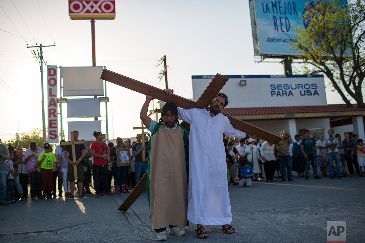 Cuban migrant Rudy Rivero leads a religious procession, adapted to reflect the plight of immigrants, in Nuevo Laredo, Tamaulipas state, Mexico, Friday March, 24, 2017, across the border from Laredo, Texas. (AP Photo/Rodrigo Abd)