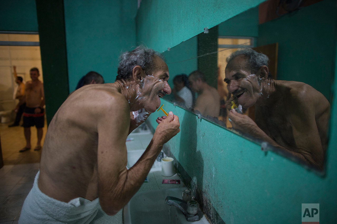 A Cuban migrant shaves at the migrant shelter "Casa del Migrante" in Nuevo Laredo, Tamaulipas state, Mexico, Saturday, March 25, 2017, across the border from Laredo, Texas. (AP Photo/Rodrigo Abd)