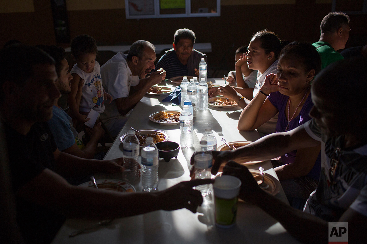 Cubans eat dinner at the migrant shelter "Casa del Migrante" in Nuevo Laredo, Tamaulipas state, Mexico, Saturday, March 25, 2017, across the border from Laredo, Texas. (AP Photo/Rodrigo Abd)