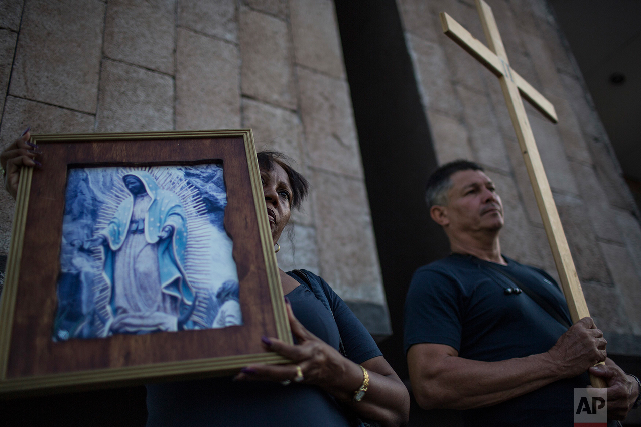 Cuban migrants hold a religious procession, adapted to reflect the plight of immigrants in Nuevo Laredo, Tamaulipas state, Mexico, Friday, March, 24, 2017, across the border from Laredo, Texas. (AP Photo/Rodrigo Abd)