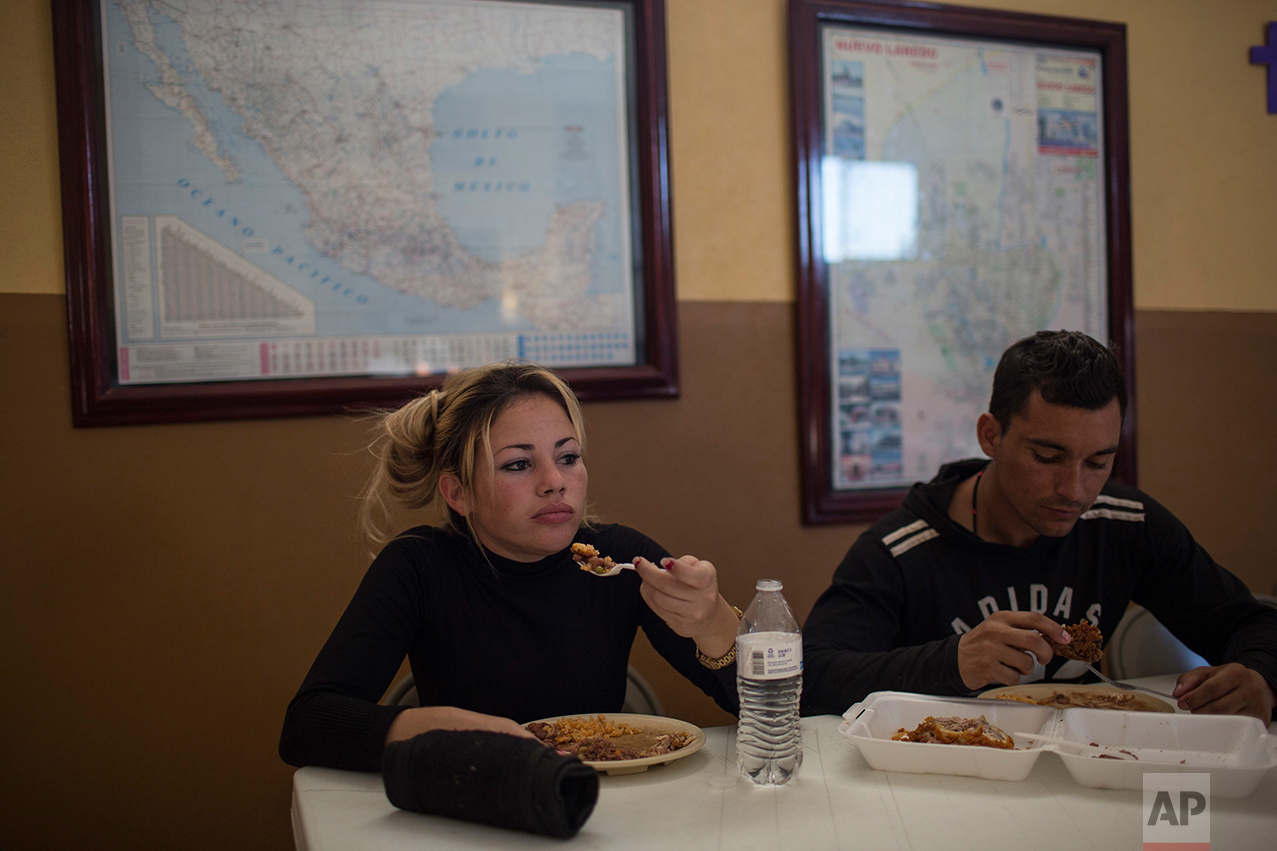 Cuban migrants Chaday Sanchez and her boyfriend Rodolfo Munoz eat dinner at the migrant shelter "Casa del Migrante" in Nuevo Laredo, Tamaulipas state, Mexico, Saturday, March 25, 2017, across the border from Laredo, Texas. (AP Photo/Rodrigo Abd)