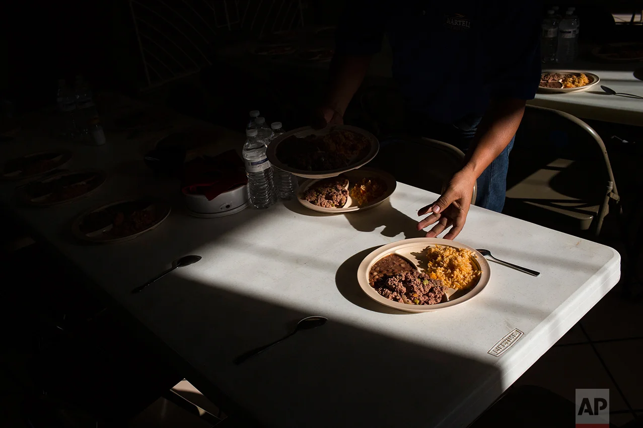 Migrants have a dinner of rice and beans at the migrant shelter "Casa del Migrante" in Nuevo Laredo, Tamaulipas state, Mexico, Saturday, March 25, 2017, across the border from Laredo, Texas. (AP Photo/Rodrigo Abd)