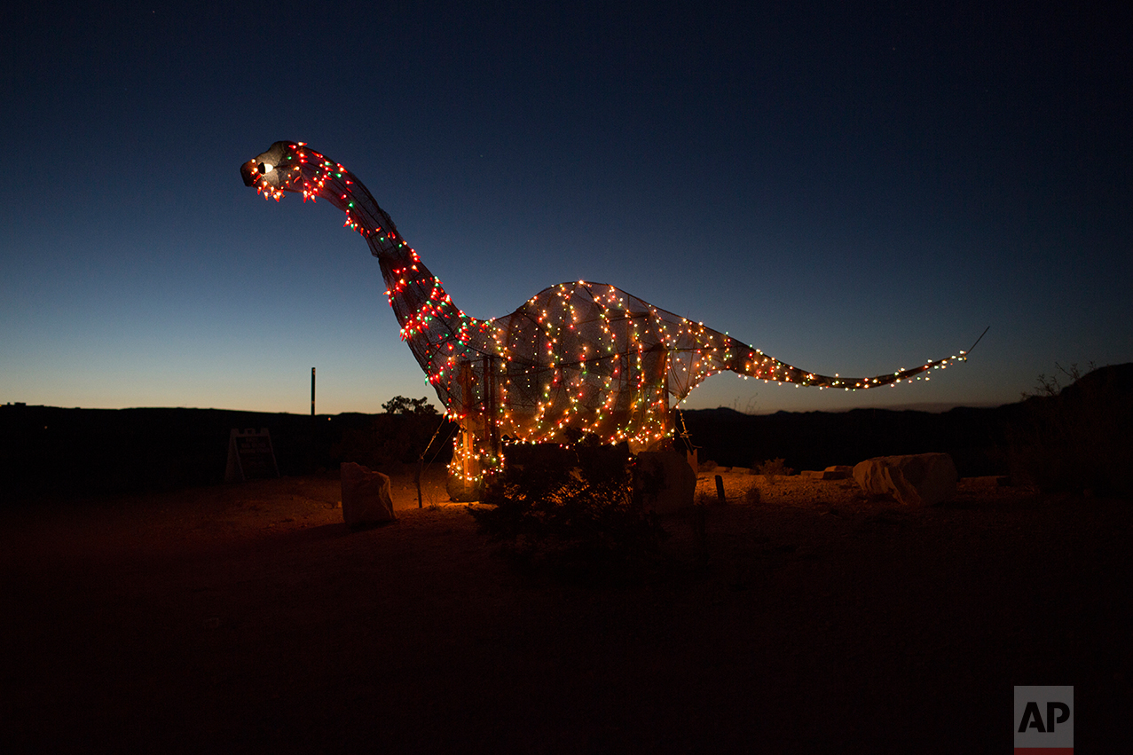  A dinosaur statue stands outside a store off the highway in Terlingua, Texas, near the US-Mexico border, Monday, March 27, 2017. (AP Photo/Rodrigo Abd) 