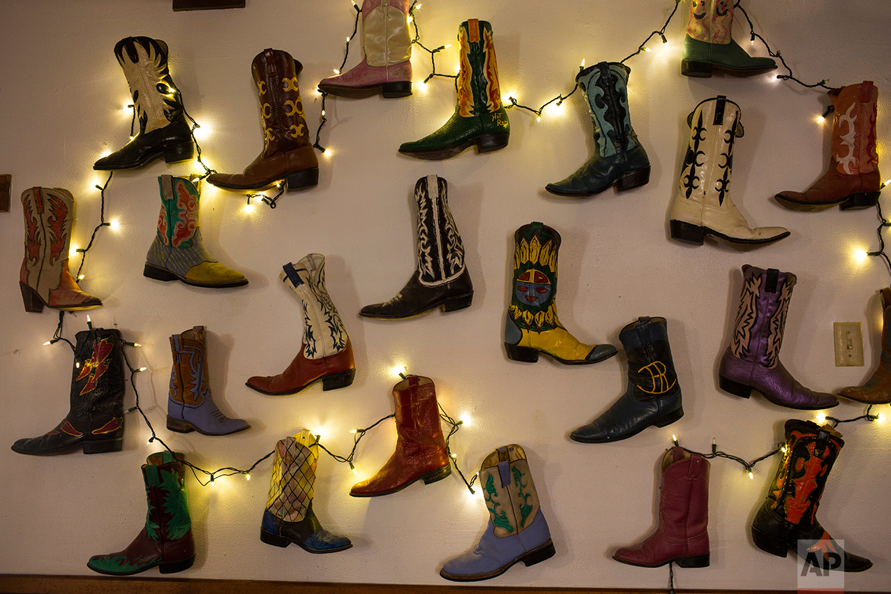  Boots decorate a wall at the Bad Rabbit Cafe in Terlingua, Texas, near the US-Mexico border, Monday, March 27, 2017. (AP Photo/Rodrigo Abd) 