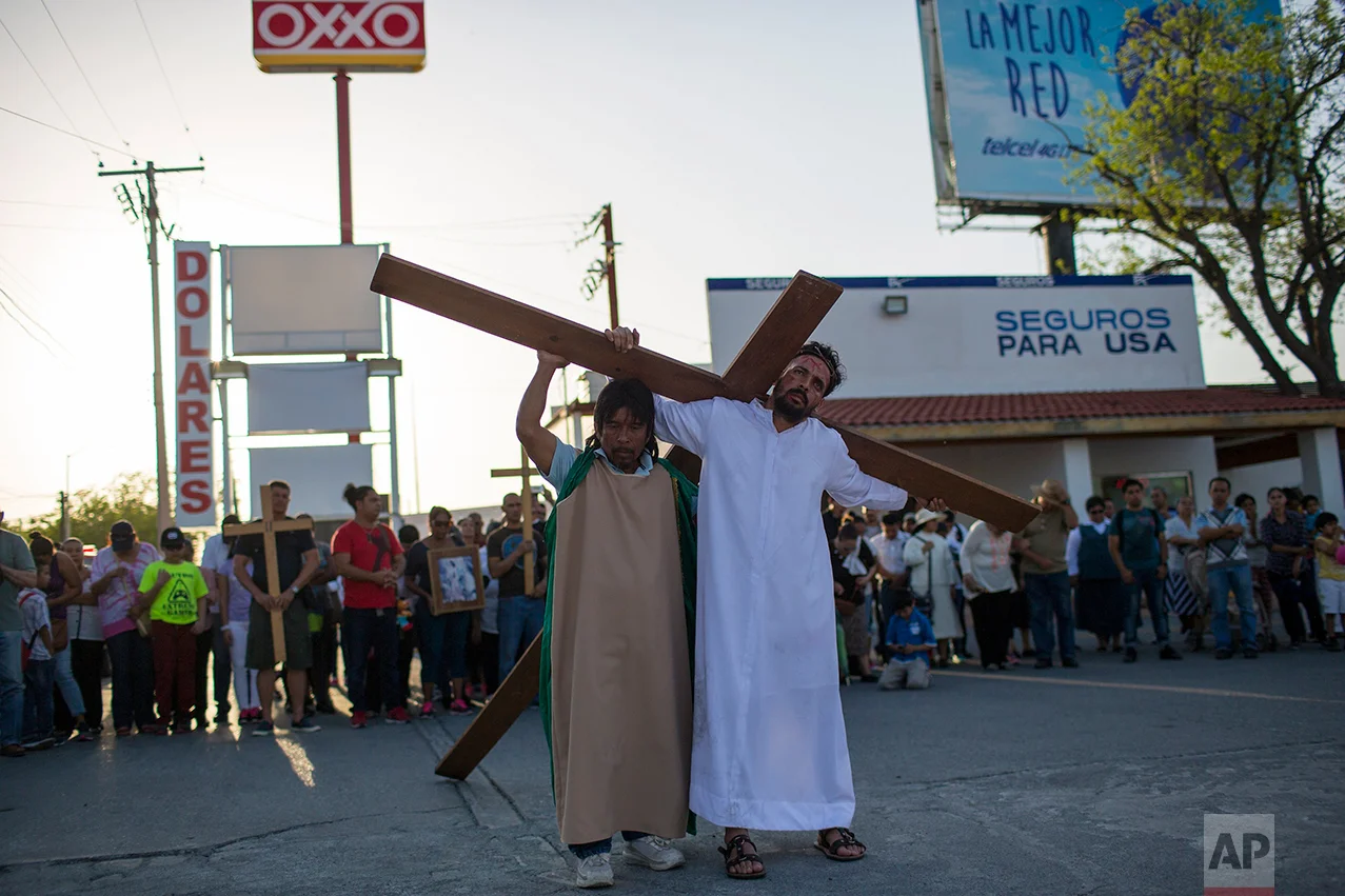 Cuban migrant Rudy Rivero leads a religious procession, adapted to reflect the plight of immigrants, in Nuevo Laredo, Tamaulipas state, Mexico, Friday March, 24, 2017, across the border from Laredo, Texas. (AP Photo/Rodrigo Abd)