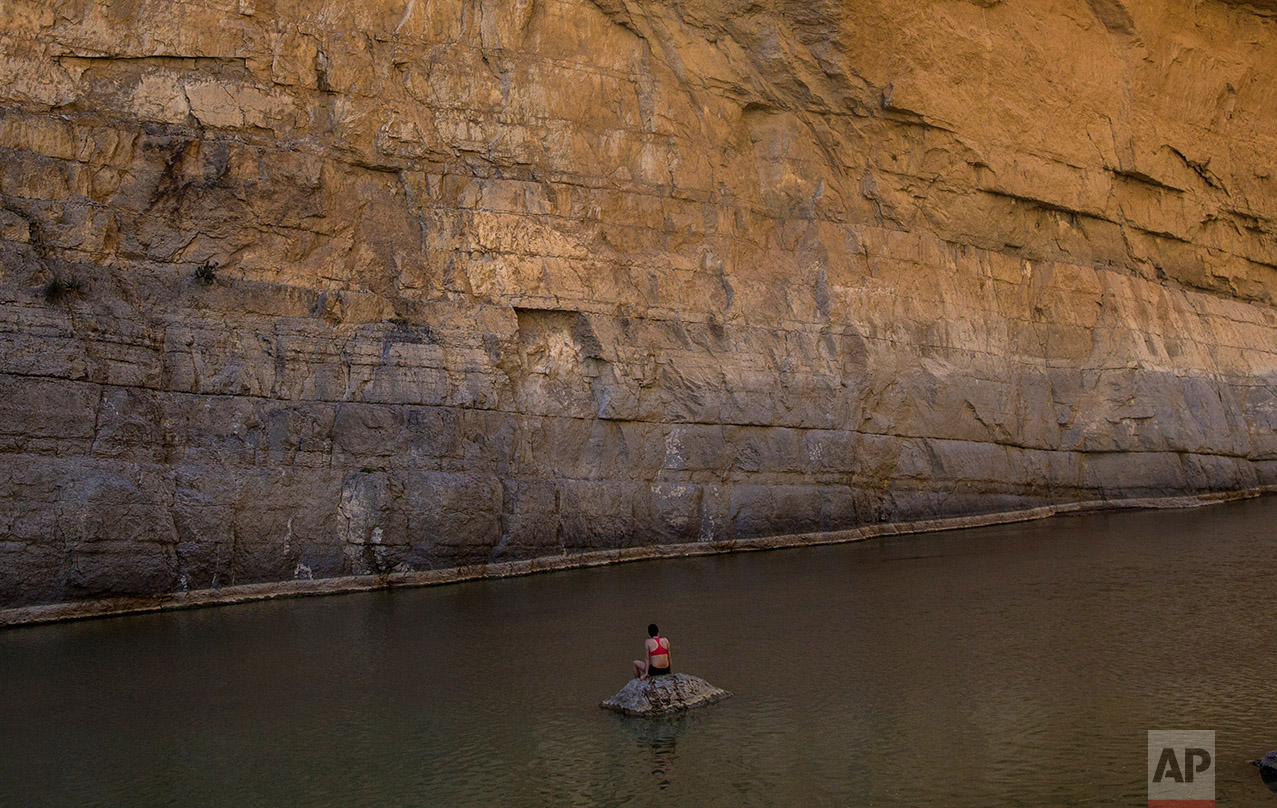 Margaret McCall, a clean energy consultant from Chicago, sits in Santa Elena Canyon in the Rio Grande river just feet from a cliff face that is Mexico, facing her, as she vacations at Big Bend National Park in Texas, Monday, March 27, 2017. When asked about the border wall, McCall said: “My first thought is: has Donald Trump seen this cliff? Because unless you’re building a 500-foot wall it’s really not going to cut it.” (AP Photo/Rodrigo Abd)