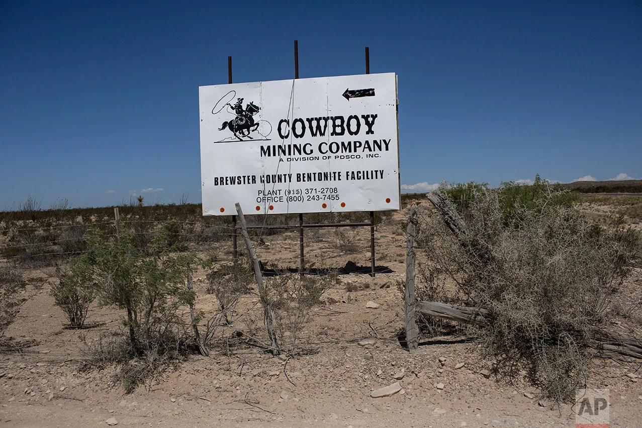 A sign advertising a mining company stands along the highway in Terlingua, Texas, about 20 miles from the US-Mexico border, Tuesday, March 28, 2017. (AP Photo/Rodrigo Abd)