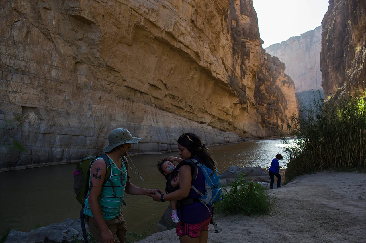 Tourists stand in Santa Elena Canyon, on the bank of the Rio Grande river, just feet from a cliff face that is Mexico, left, as they vacation at Big Bend National Park in Texas, Monday, March 27, 2017. (AP Photo/Rodrigo Abd)